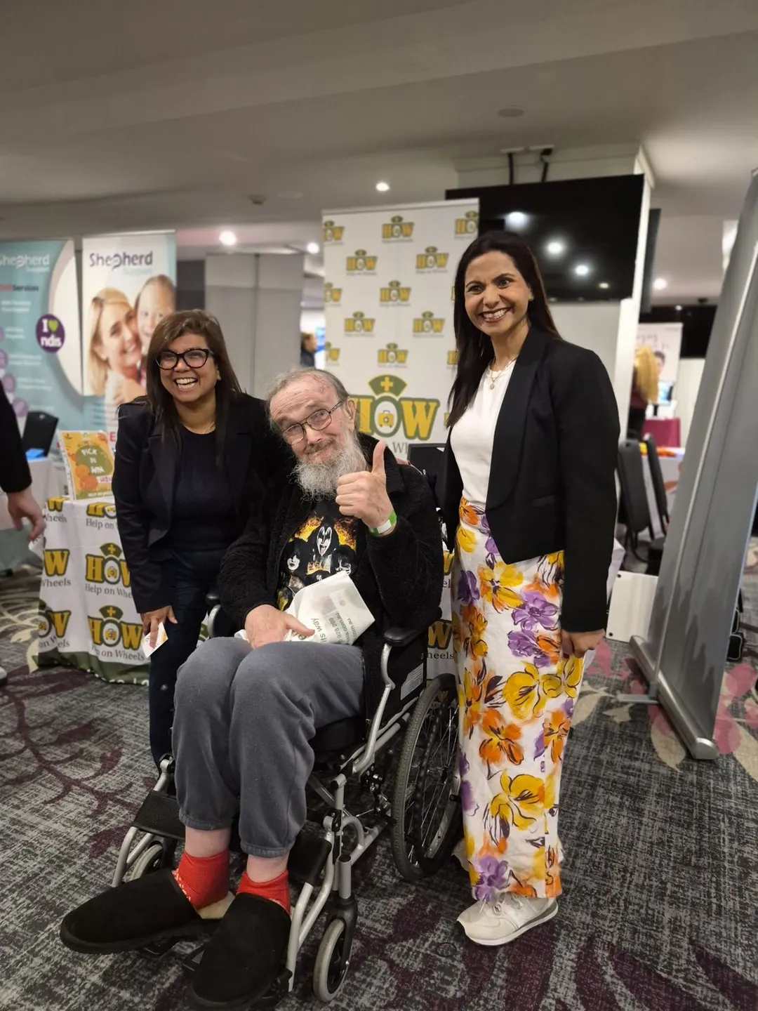 Help on Wheels team member with a participant in a wheelchair at the Sutherland Community Expo